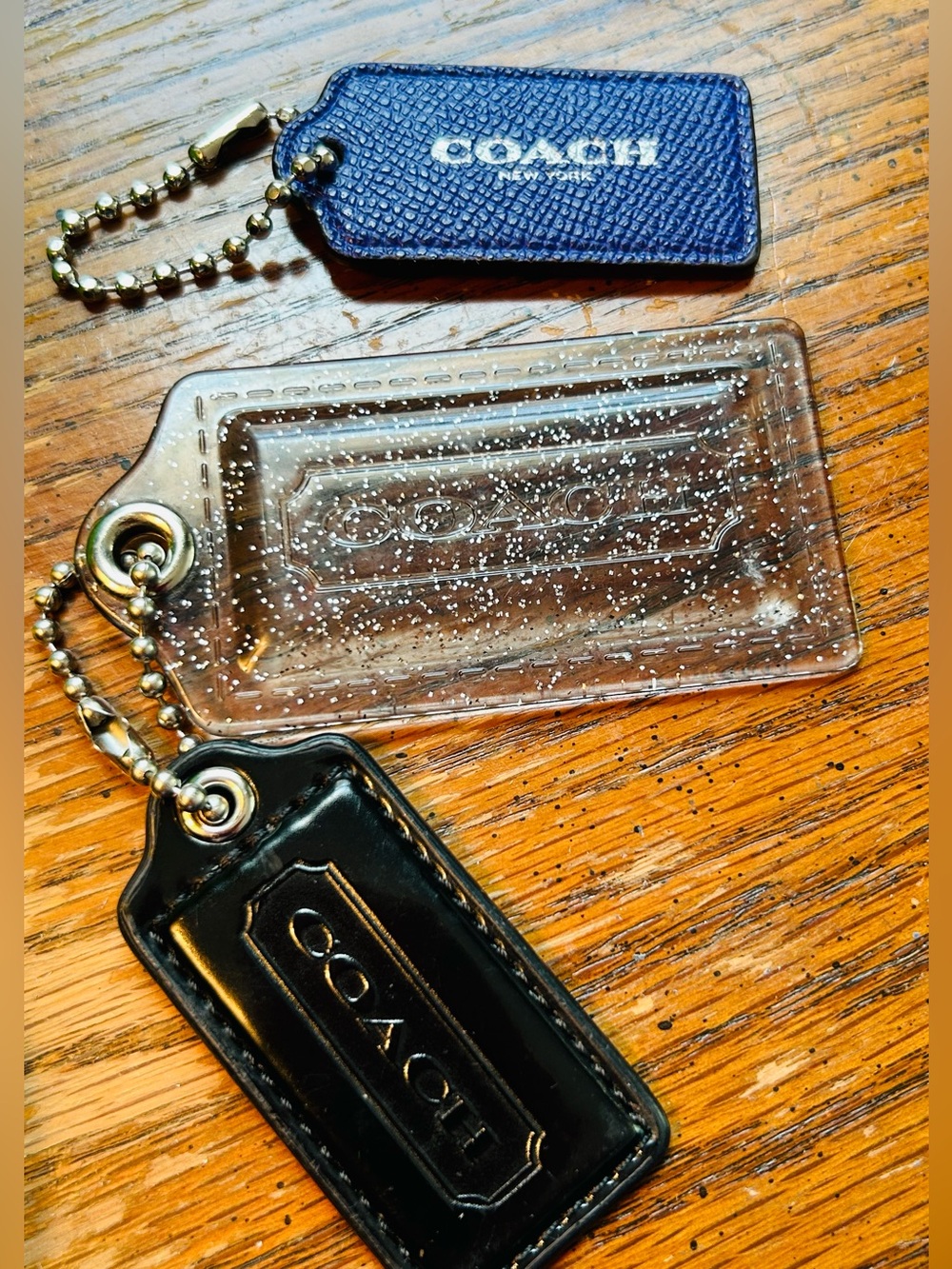 Coach Poppy Clear with Silver Sparkles, black & purple hang tags